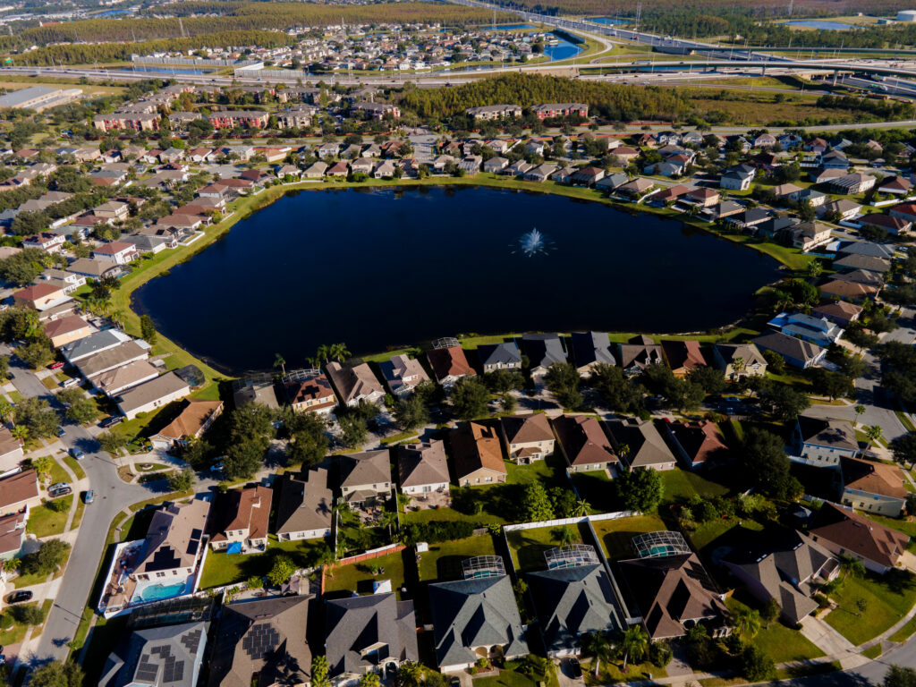Aerial view of Falcon Trace homes surrounding a lake with a fountain
